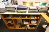 Lot 84 - WHITE 68INCH SERVING COUNTER & CONTENTS ON TOP OF COUNTER OF 9 SAMPLE BOOKS, & CONTENTS OF PIGEON HOLES BEHIND COUNTER OF MISCELLANEOUS (VAT applicable)