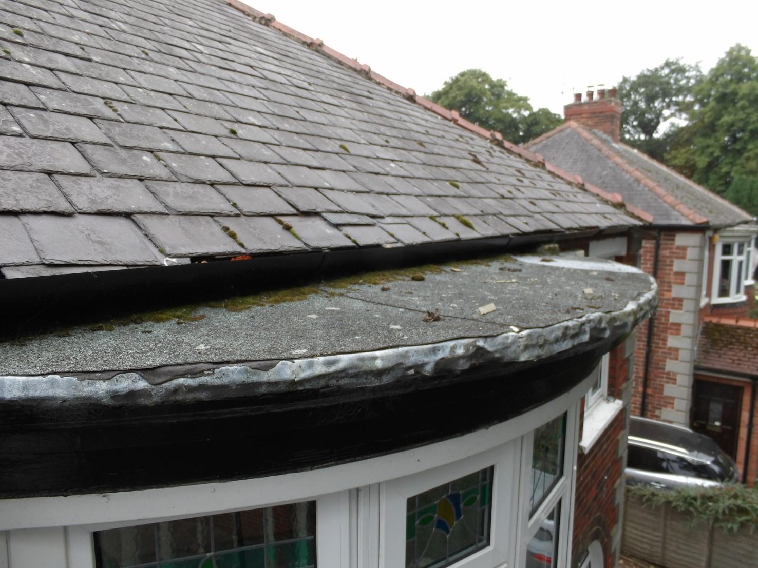 Bitumen felt laid on top of a lead covered roof of a bay window.